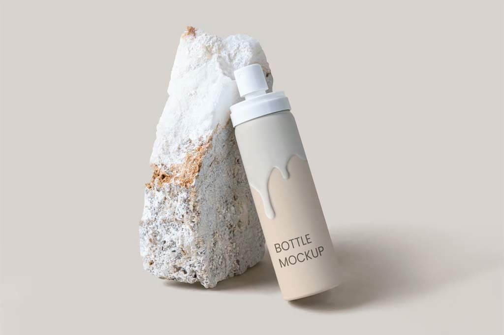 White Spray Bottle PSD Mockup Against a Rock